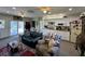 Cozy living room open to the kitchen, featuring ceiling fans, and easy access to the backyard at 1136 Granada St, Clearwater, FL 33755