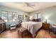 Bedroom with wood floors, windows, and a ceiling fan, offering a calm and relaxing space at 1136 Granada St, Clearwater, FL 33755