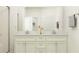 Elegant bathroom featuring a double sink vanity with a modern countertop and fixtures at 11828 Sparkling Topaz Cv, Parrish, FL 34219