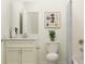 Bright bathroom with white vanity, marble countertop, and classic subway tile shower at 11828 Sparkling Topaz Cv, Parrish, FL 34219