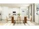 Bright dining area featuring modern chairs, a table, and an adjacent open kitchen at 11828 Sparkling Topaz Cv, Parrish, FL 34219