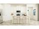 Bright kitchen featuring white cabinets, stainless steel appliances, and stylish island seating at 11828 Sparkling Topaz Cv, Parrish, FL 34219