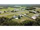 Stunning aerial view of a residential airpark featuring a runway and beautiful homes nestled amongst lush trees at 11908 Pilot Country Dr, Spring Hill, FL 34610