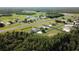 An impressive aerial view of a rural residential airpark with a functional runway surrounded by picturesque houses and nature at 11908 Pilot Country Dr, Spring Hill, FL 34610