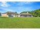 Wide backyard showcasing a home with a screened patio at 11908 Pilot Country Dr, Spring Hill, FL 34610