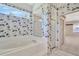 Bathroom view showcasing a sunken tub, glass enclosed shower, and access to the main bedroom area at 11908 Pilot Country Dr, Spring Hill, FL 34610