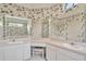 Bathroom view showcasing a large mirror over a vanity with dual sinks and a make up table at 11908 Pilot Country Dr, Spring Hill, FL 34610