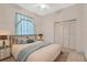 Bedroom showcasing a ceiling fan, window, bed with nightstands and a closet at 11908 Pilot Country Dr, Spring Hill, FL 34610