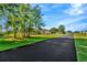 Spacious home featuring a long driveway leading to a beautiful yard and a residence at 11908 Pilot Country Dr, Spring Hill, FL 34610