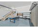 Large garage with a staircase to the loft, shelving, and a blue workbench at 11908 Pilot Country Dr, Spring Hill, FL 34610