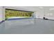 Spacious garage with high ceilings and room for multiple vehicles, plus a long driveway and lush landscaping at 11908 Pilot Country Dr, Spring Hill, FL 34610