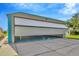 Airplane hangar partially open, revealing space for aircraft and aviation equipment at 11908 Pilot Country Dr, Spring Hill, FL 34610