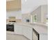 Bright white kitchen with a breakfast bar overlooking the open living space at 11908 Pilot Country Dr, Spring Hill, FL 34610