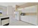 Bright kitchen features white cabinets, appliances, and tile flooring, creating a clean and functional space at 11908 Pilot Country Dr, Spring Hill, FL 34610