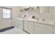 Well-lit laundry room with modern appliances and ample counter space at 11908 Pilot Country Dr, Spring Hill, FL 34610