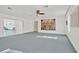 Open-concept living room with sliding glass doors to the outside, and a ceiling fan at 11908 Pilot Country Dr, Spring Hill, FL 34610