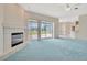 Open concept living room with fireplace, and sliding glass doors to an outdoor lanai at 11908 Pilot Country Dr, Spring Hill, FL 34610