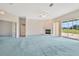 Large living room features a fireplace, ceiling fan, and sliding doors to the screened lanai at 11908 Pilot Country Dr, Spring Hill, FL 34610