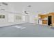 Spacious living room with natural light, a ceiling fan, and access to the kitchen at 11908 Pilot Country Dr, Spring Hill, FL 34610