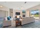 Open living room featuring two couches, a fireplace, and sliding glass doors to the lanai at 11908 Pilot Country Dr, Spring Hill, FL 34610