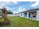 Spacious backyard including play set, a privacy fence and well-maintained grass at 12138 Criollo Rd, Spring Hill, FL 34610