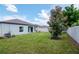 Lush backyard featuring well-maintained lawn, privacy fence, and backyard access at 12138 Criollo Rd, Spring Hill, FL 34610