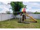 Backyard showcasing play set with swings, slide and climbing rungs at 12138 Criollo Rd, Spring Hill, FL 34610