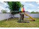 Backyard showcasing play set with swings, slide and climbing rungs at 12138 Criollo Rd, Spring Hill, FL 34610
