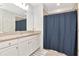 Bright bathroom featuring granite countertop, white cabinetry, and tub with shower curtain at 12138 Criollo Rd, Spring Hill, FL 34610