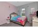 Charming ' bedroom with a pink accent wall, a soft color palette, and a window for natural light at 12138 Criollo Rd, Spring Hill, FL 34610