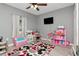 bedroom with gray walls, wood floor, and toys at 12138 Criollo Rd, Spring Hill, FL 34610