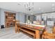 Cozy dining area connecting kitchen and living spaces, featuring a wooden table, chandelier, and ample seating at 12138 Criollo Rd, Spring Hill, FL 34610