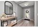 Inviting foyer with light gray walls, wood-look floors, and stylish console table with elegant decor at 12138 Criollo Rd, Spring Hill, FL 34610