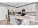 Modern kitchen with white cabinets, granite countertops, stainless steel appliances, and island seating at 12138 Criollo Rd, Spring Hill, FL 34610