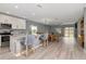Open-concept kitchen flows into the dining and living area, complete with modern appliances and island seating at 12138 Criollo Rd, Spring Hill, FL 34610