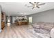 Expansive open-concept living and dining area featuring wood-look floors, modern lighting, and plenty of space at 12138 Criollo Rd, Spring Hill, FL 34610