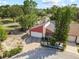 An aerial view of the two-story house and landscaping, surrounded by mature trees at 12234 Cider Mill Ln, Hudson, FL 34667