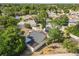 Aerial view of lovely home with grey shingled roof, back patio, and mature trees at 12234 Cider Mill Ln, Hudson, FL 34667