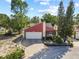 An elevated view of the two-story house featuring a 2-car garage and meticulous landscaping at 12234 Cider Mill Ln, Hudson, FL 34667