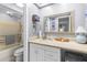 Well-lit bathroom with vanity, countertop, and a shower-tub combo with handrails at 12234 Cider Mill Ln, Hudson, FL 34667