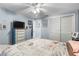 Charming bedroom has blue walls, patterned duvet cover, and a closet with sliding doors at 12234 Cider Mill Ln, Hudson, FL 34667