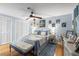 Comfortable bedroom featuring a ceiling fan, blue walls, and lots of natural light at 12234 Cider Mill Ln, Hudson, FL 34667