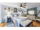 Inviting bedroom with a quilt-covered bed, ceiling fan and warm, natural light at 12234 Cider Mill Ln, Hudson, FL 34667