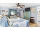 A calming bedroom with a cozy, quilted bed, a ceiling fan, and neutral-colored walls at 12234 Cider Mill Ln, Hudson, FL 34667