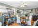 Bright dining area with charming decor, a view into the kitchen, and white ceiling fan at 12234 Cider Mill Ln, Hudson, FL 34667