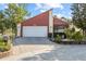 Inviting home featuring an attached two-car garage and well-manicured landscaping at 12234 Cider Mill Ln, Hudson, FL 34667