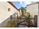 A walkway between two tan buildings with a brown picket fence and green shrubbery at 12234 Cider Mill Ln, Hudson, FL 34667