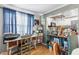 Cozy office nook with natural light, blue curtains and wood-style flooring at 12234 Cider Mill Ln, Hudson, FL 34667