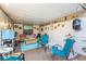 Covered patio with colorful seating, outdoor fan, and unique decorations at 12234 Cider Mill Ln, Hudson, FL 34667