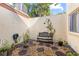 Private patio with stone and gravel ground cover, bench and various potted plants at 12234 Cider Mill Ln, Hudson, FL 34667